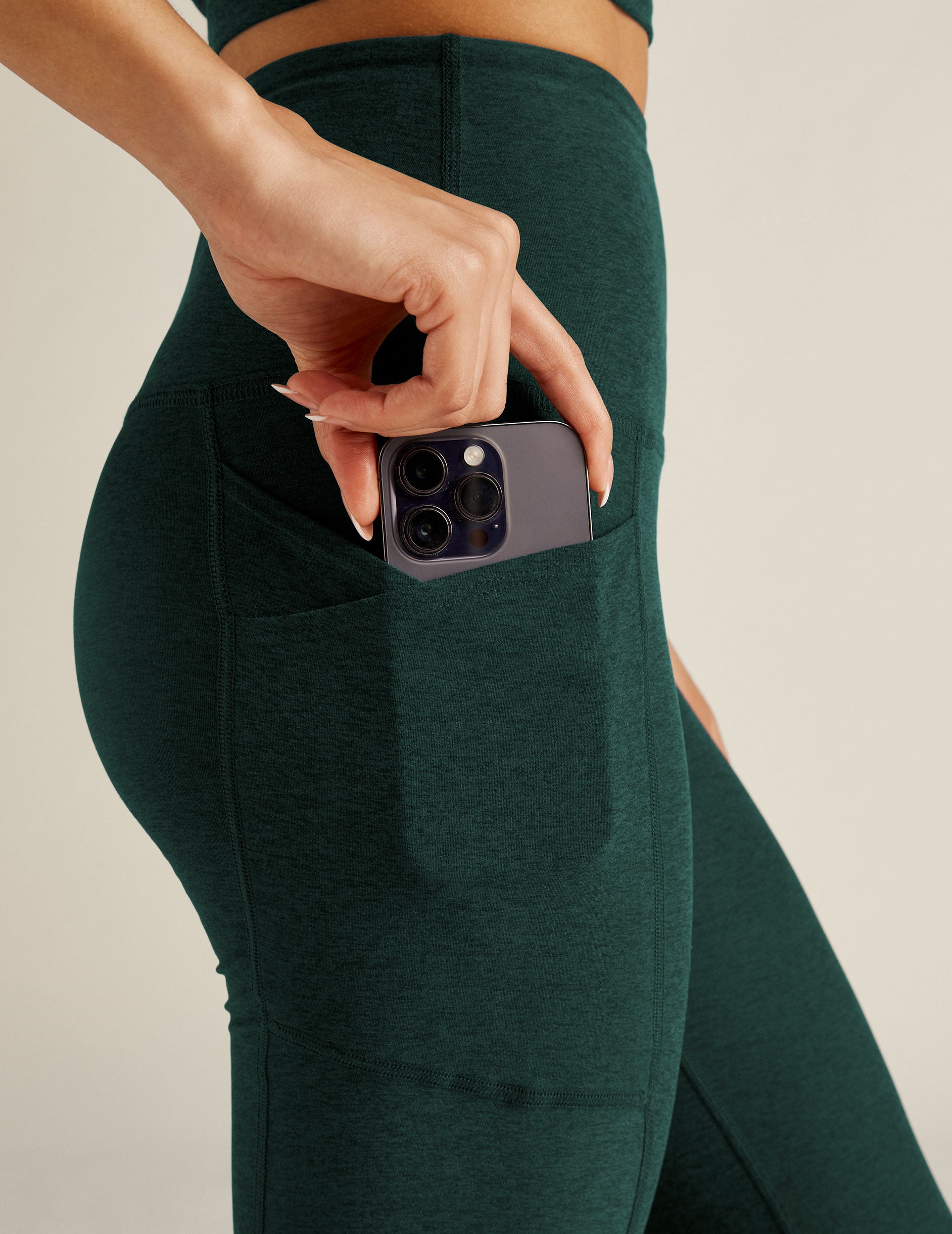 green high-waisted bootcut leggings with front side pockets. 