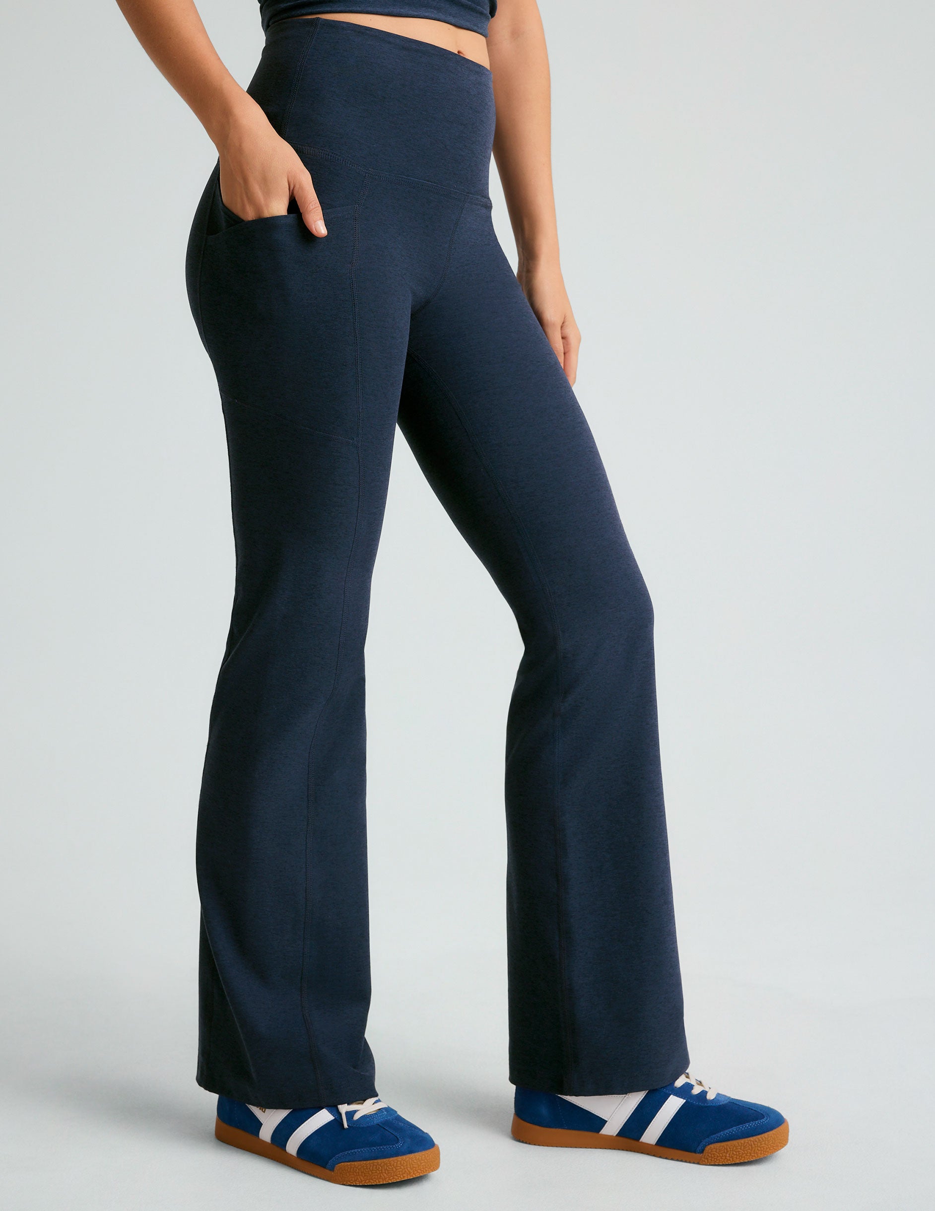 blue high-waisted bootcut leggings with front side pockets. 