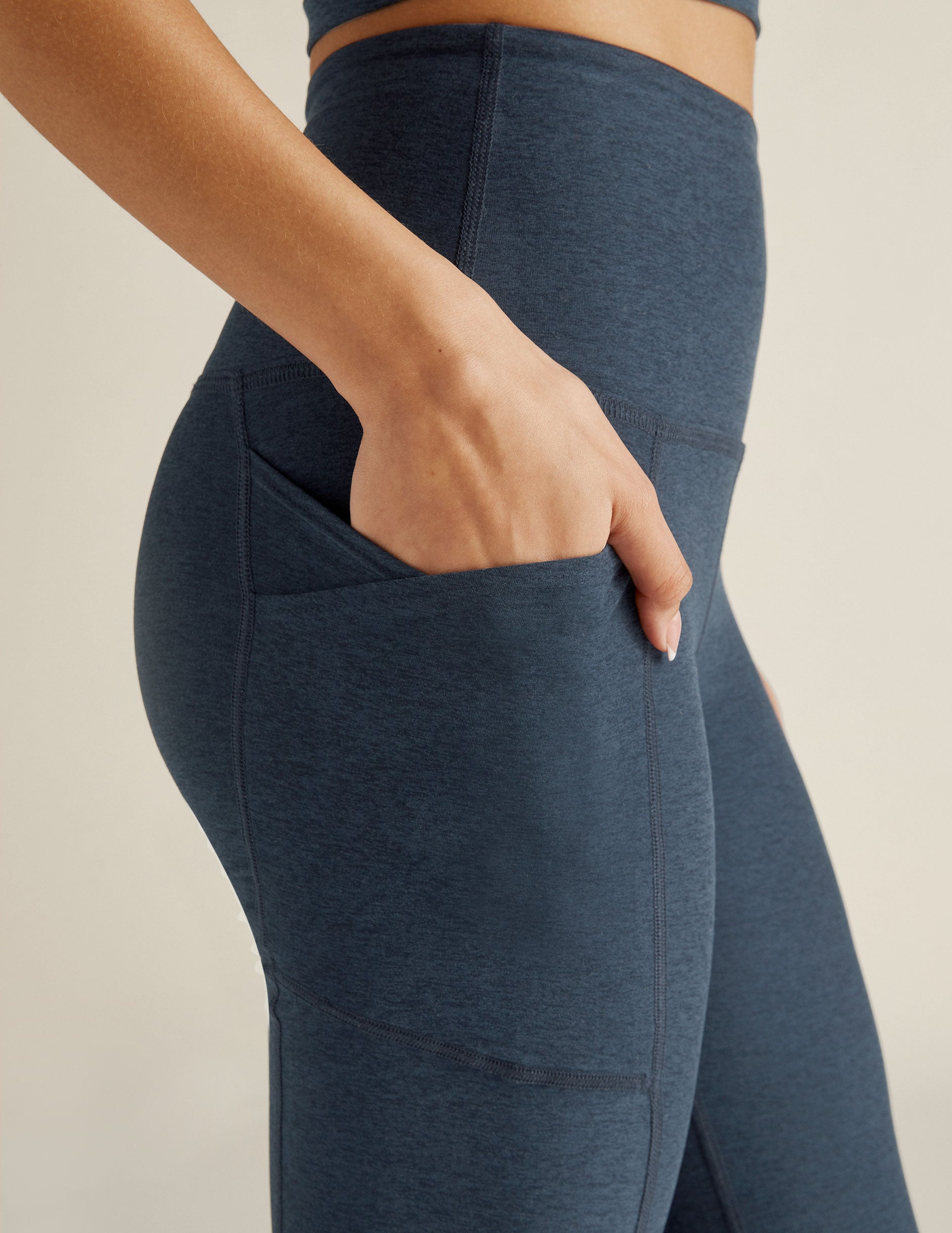 blue high-waisted bootcut leggings with front side pockets. 