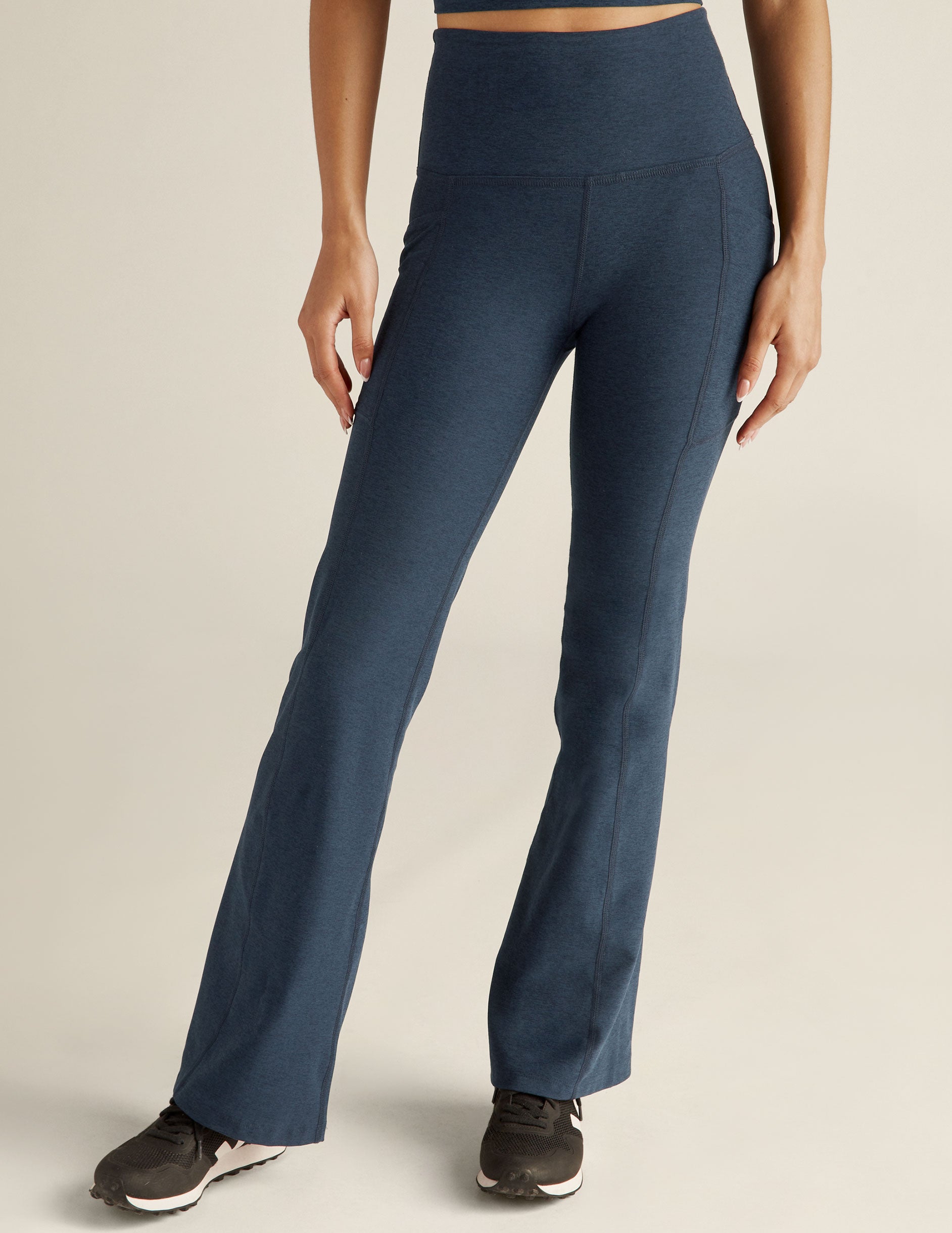 blue high-waisted bootcut leggings with front side pockets. 