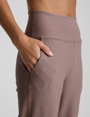 Brown pants worn by a person on a light gray background. 