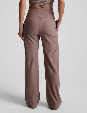 Brown pants worn by a person on a light gray background. 
