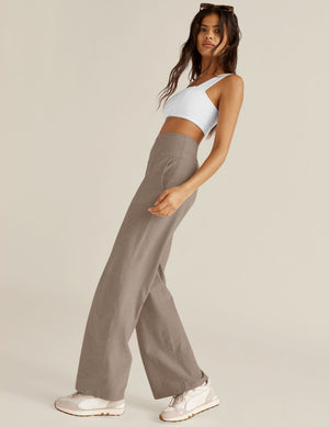 Model wearing the high-waisted Spacedye Laid Back Pant in marled Birch Heather, featuring a relaxed wide leg and pockets.