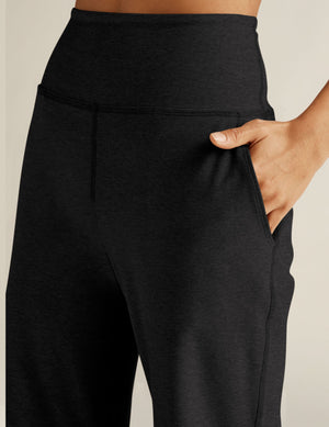 A close-up of the black marled Spacedye Laid Back Pant featuring a high waistband and a hand in the side slant pocket.