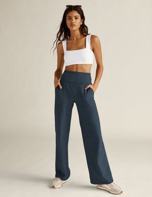 A model wears the navy Spacedye Laid Back Pant featuring a high waistband, wide legs, and side pockets in a marled texture.
