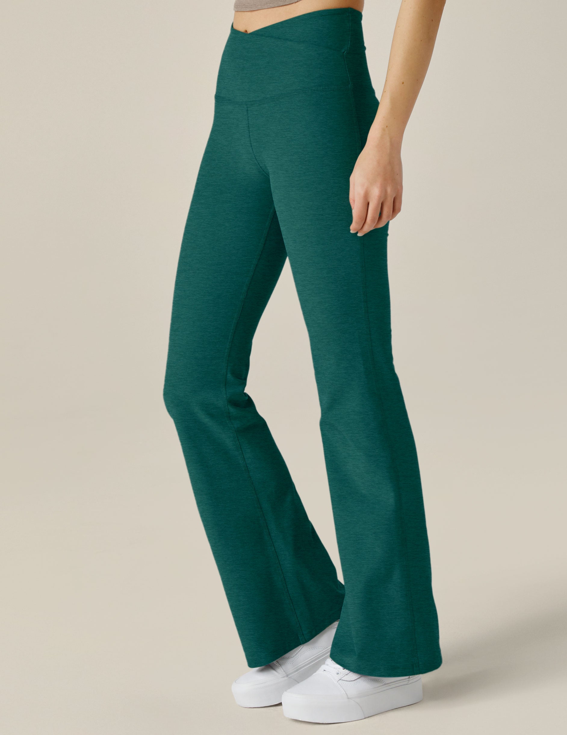 green bootcut legging with crossover design on waistband
