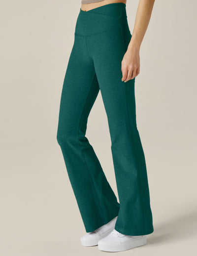 green bootcut legging with crossover design on waistband