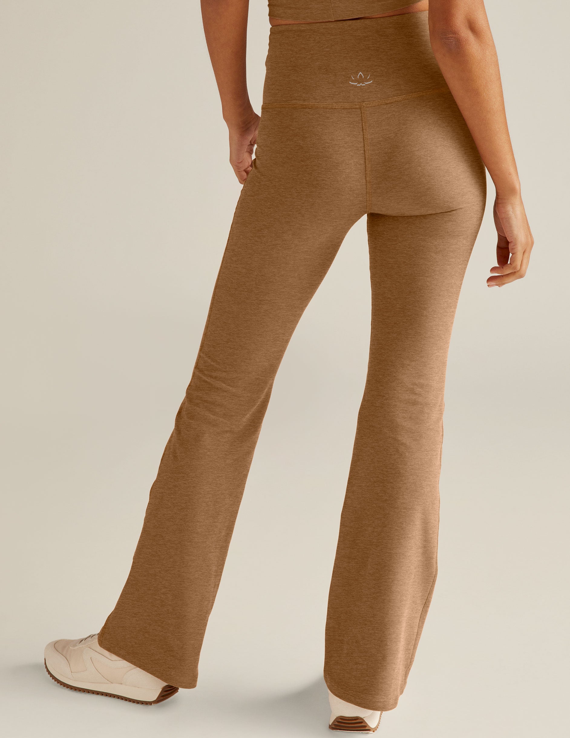 brown high-waisted flare leggings with a crossover detailing on the front waistband.
