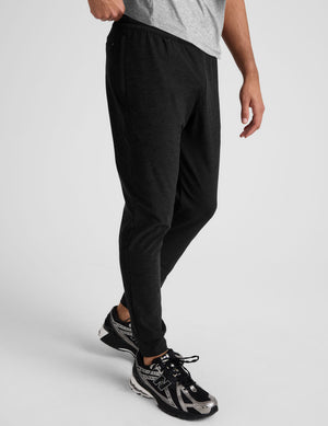 black jogger pants on a plain background. 