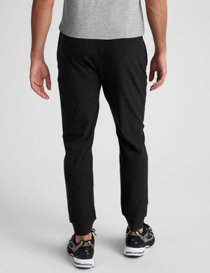 black jogger pants on a plain background. 