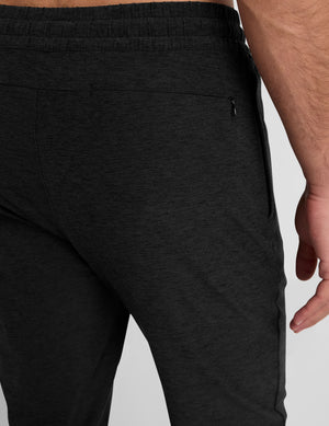 black jogger pants on a plain background. 