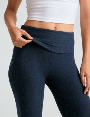 Navy marled Spacedye Foldover Bootcut Pant with a hand lifting the foldover waistband to show the high-waisted fit.