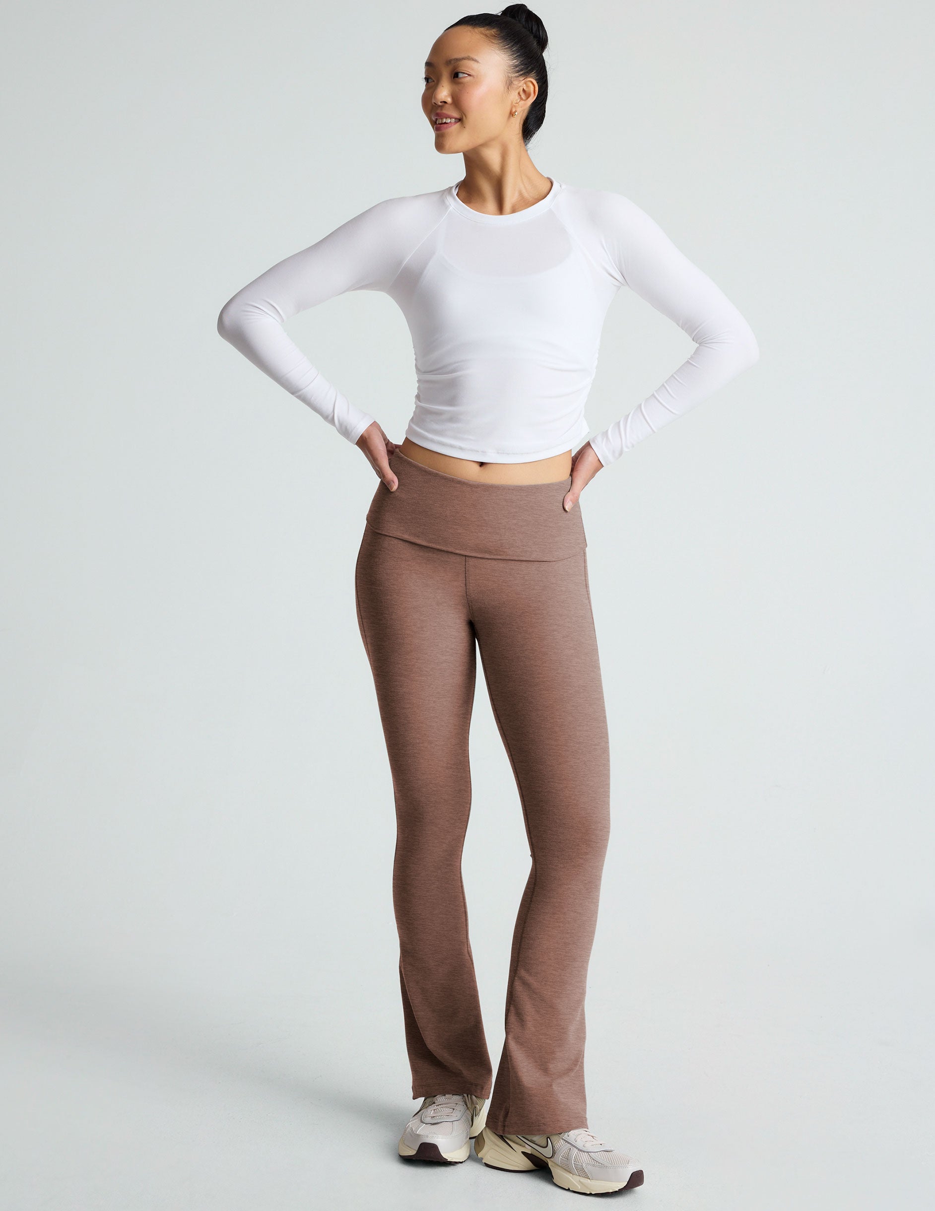 brown high-waisted bootcut flare leggings with a foldover waistband. 