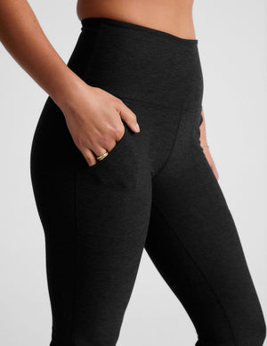 black high-waisted bootcut pants with side pockets. 