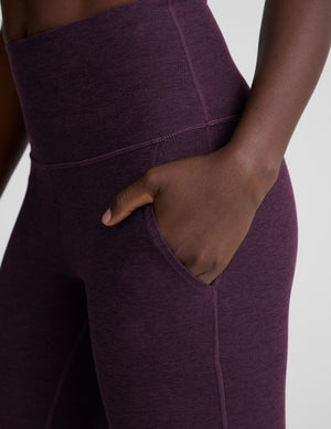 Close-up of a hand in the pocket of the purple Spacedye High Waisted Practice Pocket Bootcut Pant showing textured fabric.