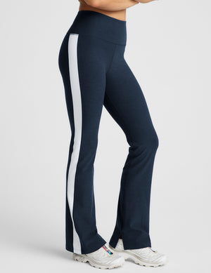 blue high-waisted bootcut pants with white contrast trim on the sides. 