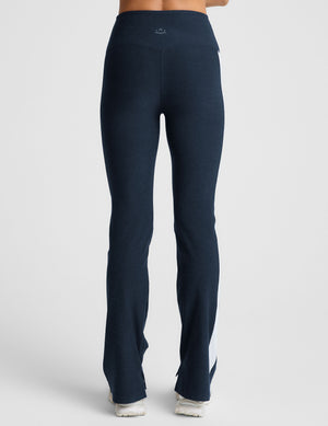 blue high-waisted bootcut pants with white contrast trim on the sides. 
