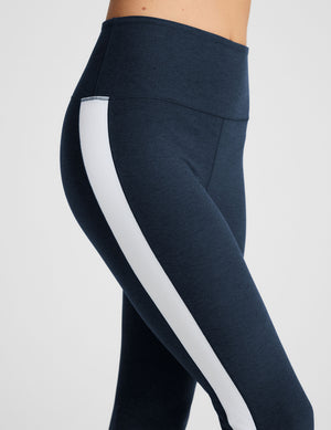 blue high-waisted bootcut pants with white contrast trim on the sides. 