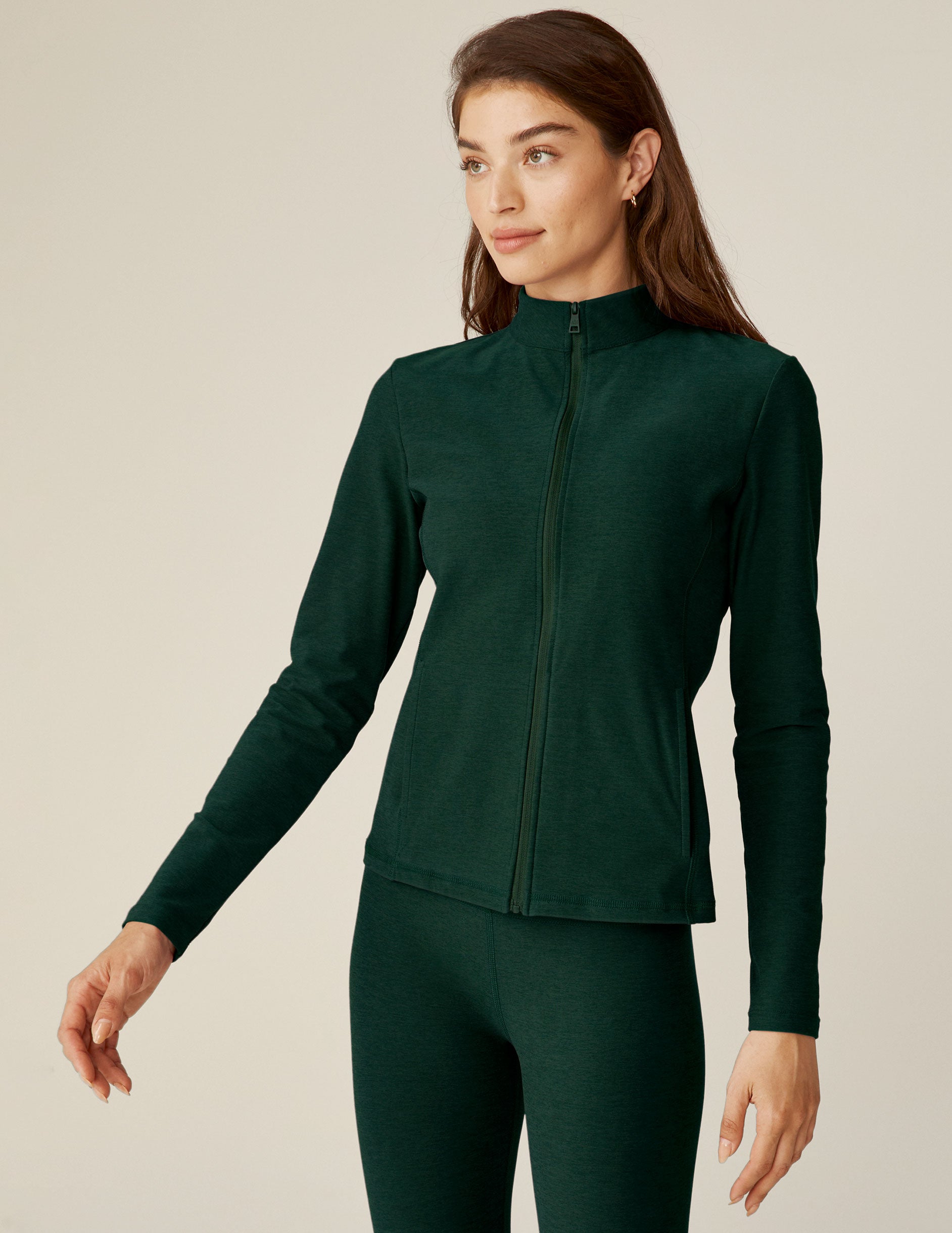 green zip-up mock neck jacket with side pockets. 