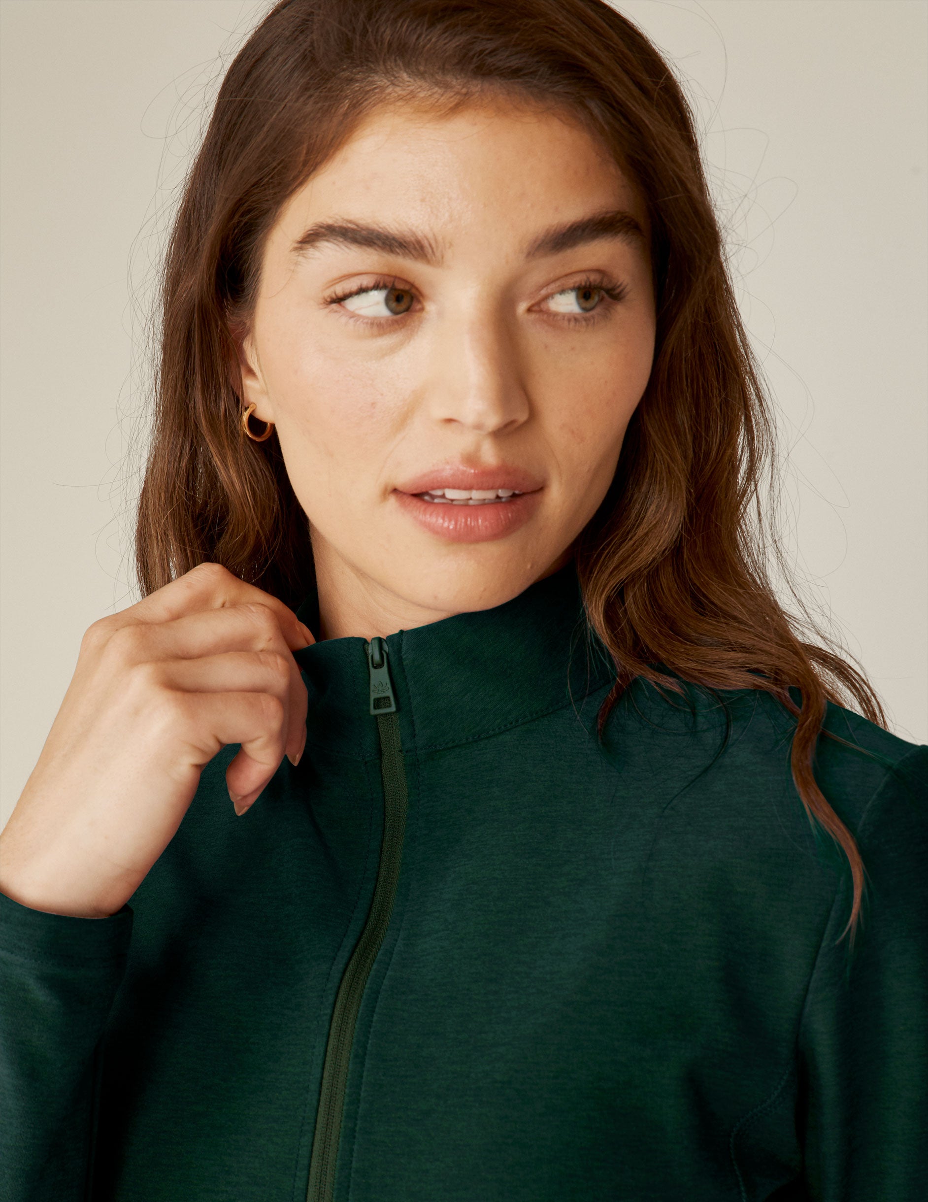 green zip-up mock neck jacket with side pockets. 