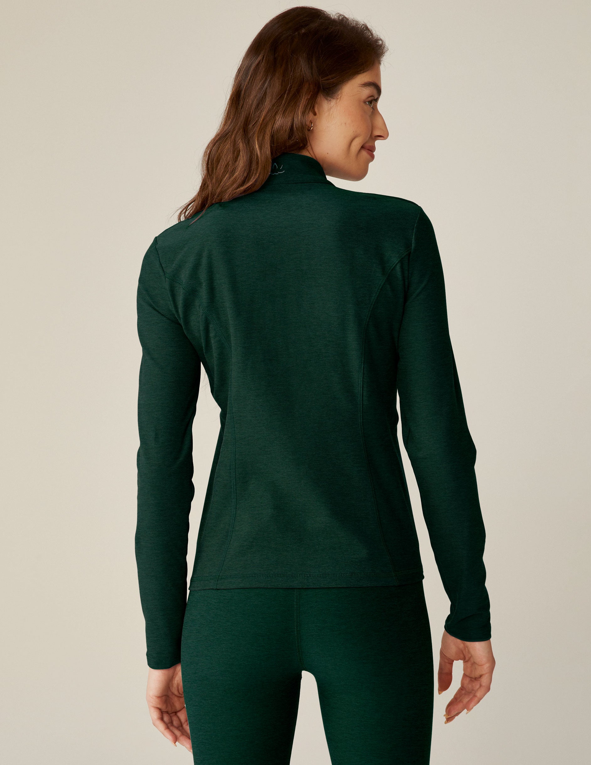 green zip-up mock neck jacket with side pockets. 