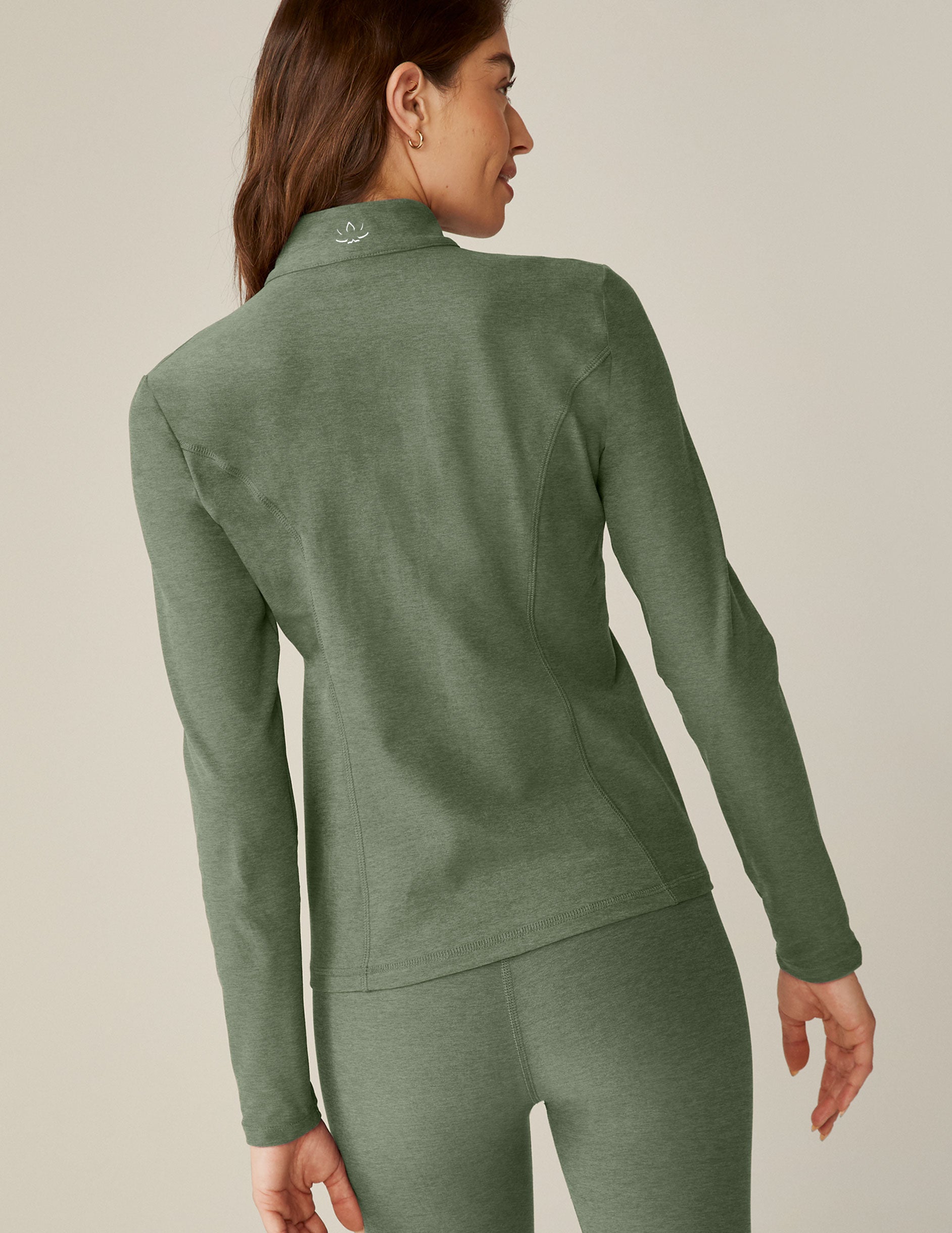 green mock-neck zip-up jacket with pockets.