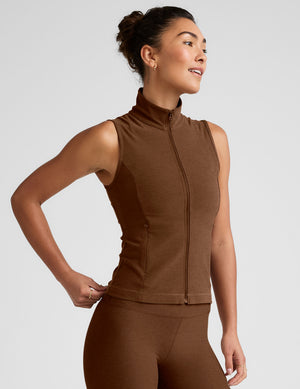 brown zip-up vest with a mesh upper back detail and pockets. 