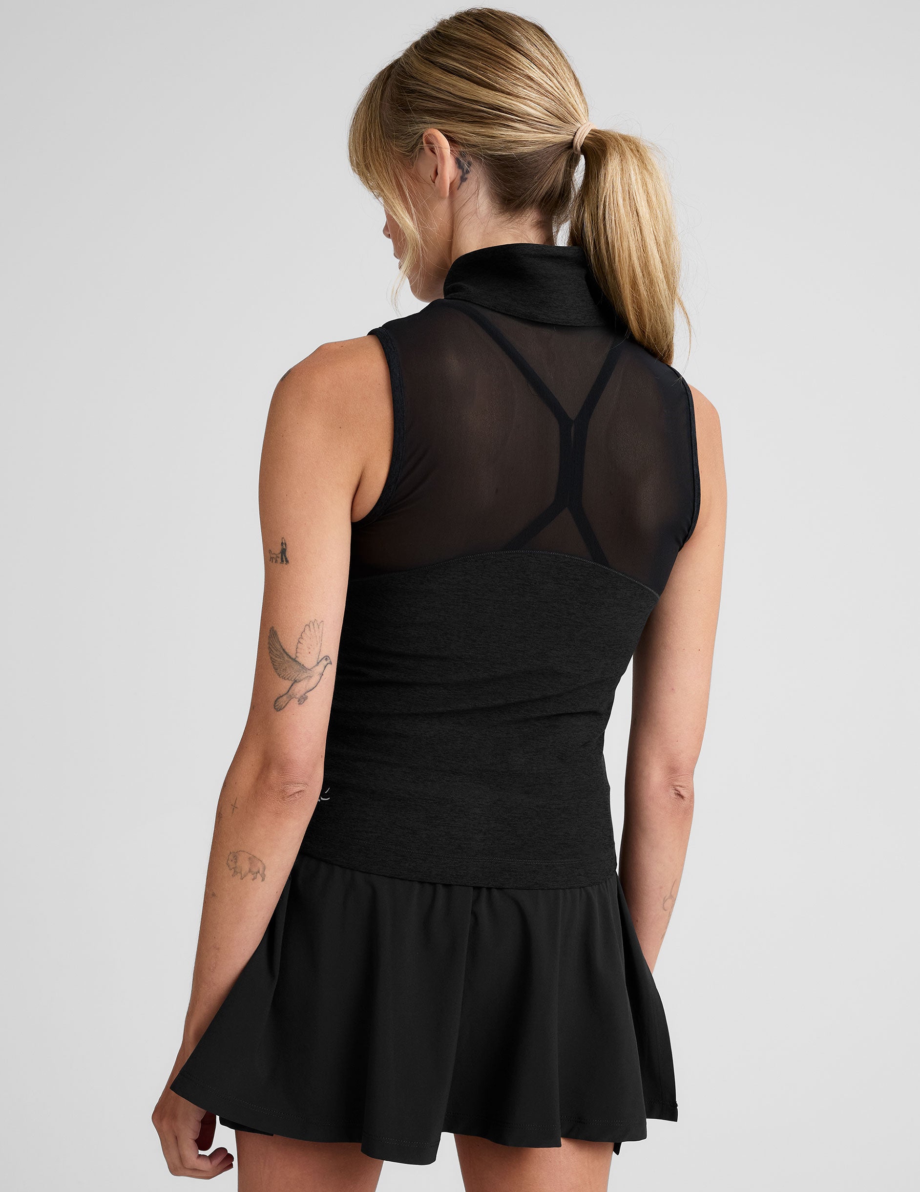 black zip-up vest with a mesh upper back detail. 