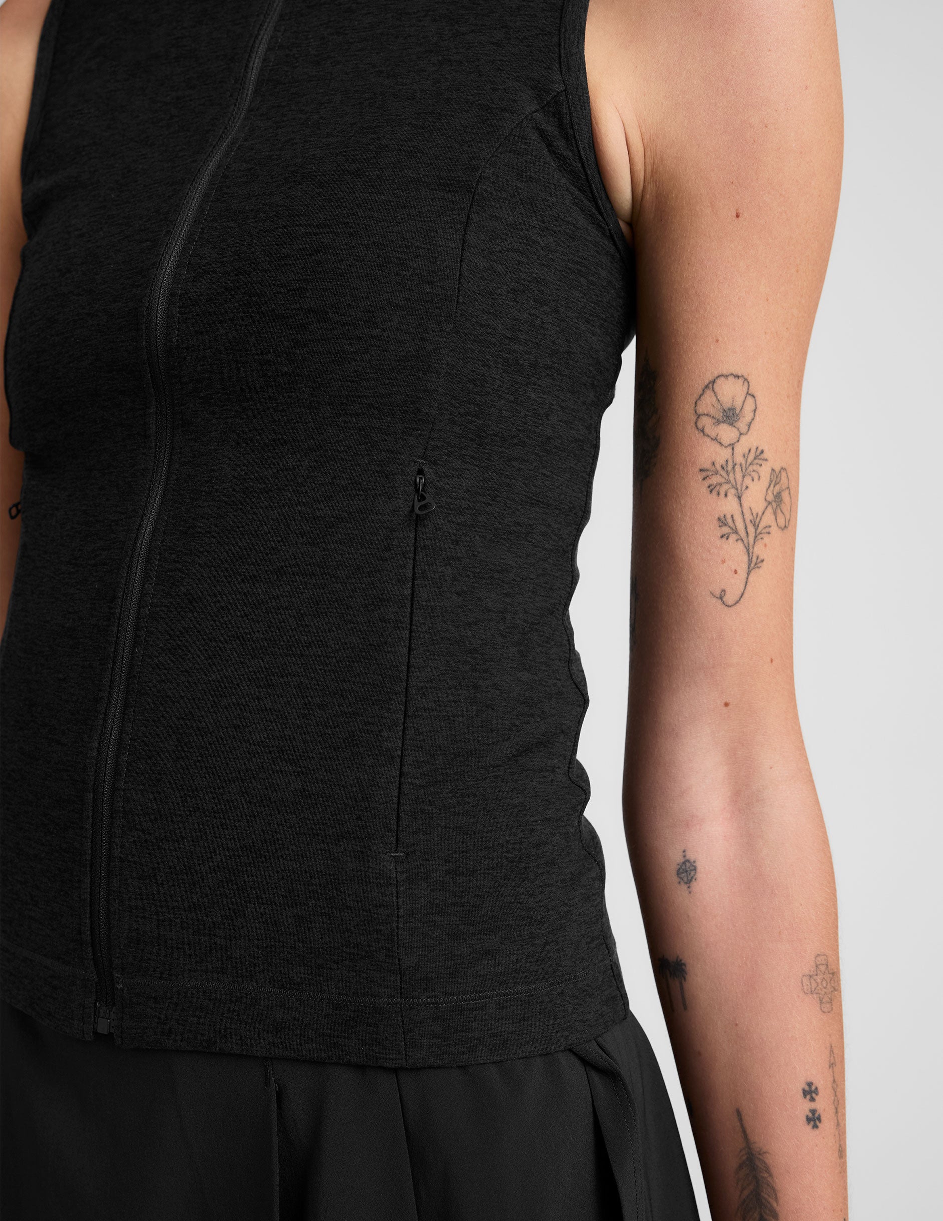 black zip-up vest with a mesh upper back detail. 