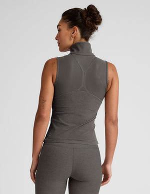 grey zip-up vest with mesh detail on upper back and pockets. 
