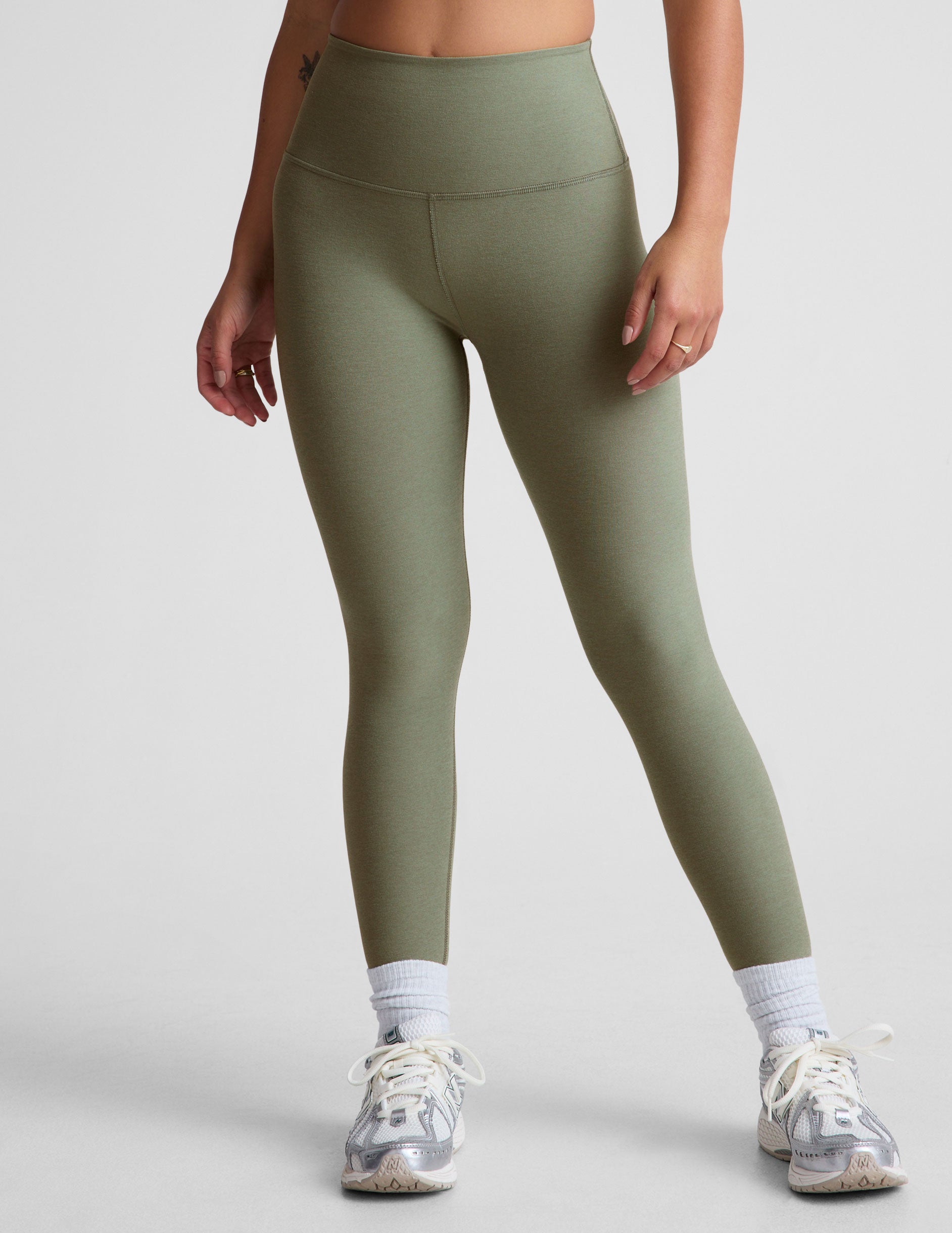 green high-waisted midi length leggings. 