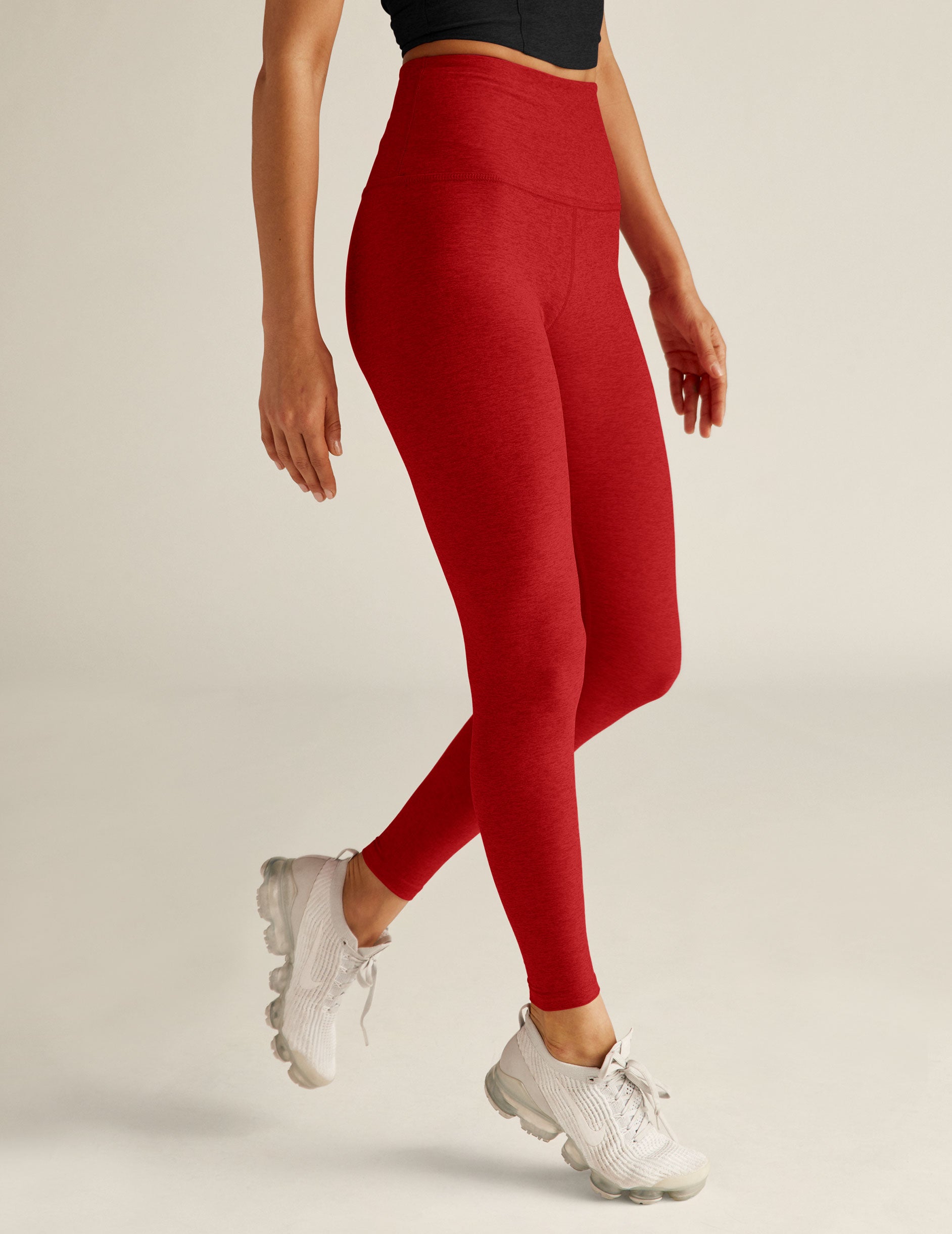 red high-waisted midi length leggings. 