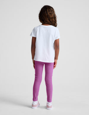 Child wearing a white t-shirt and purple pants on a plain background. 