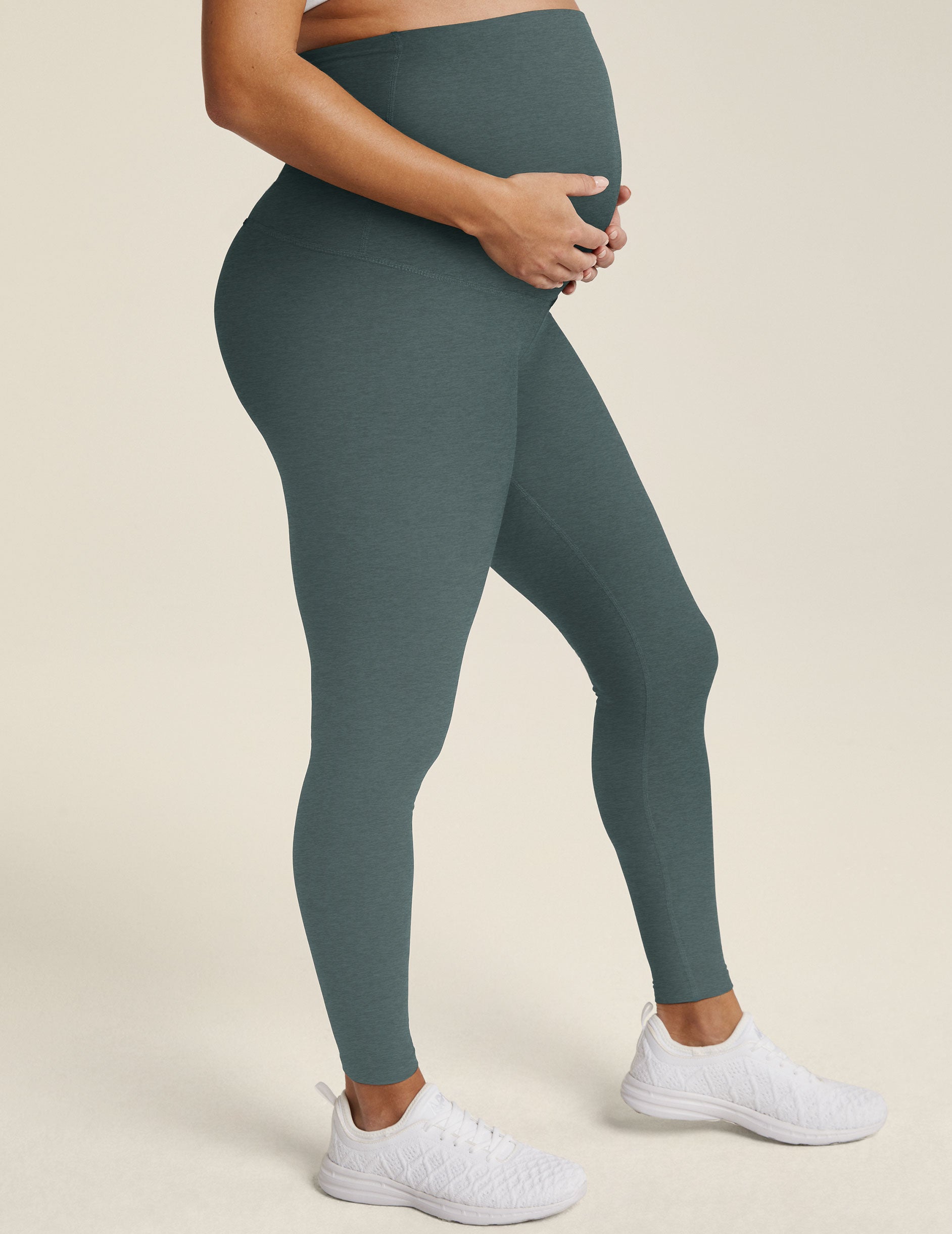 model is wearing blue maternity midi leggings. 