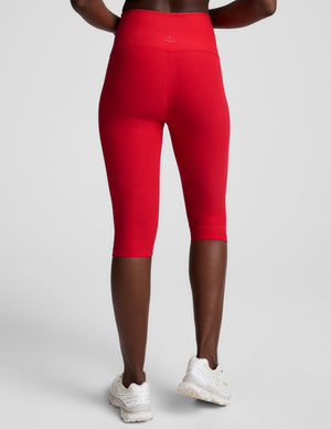 red high-waisted pedal pusher length leggings. 