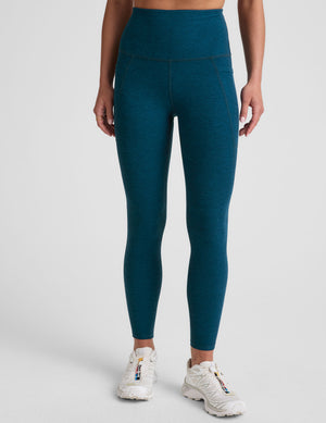 blue high-waisted midi length leggings with side pockets. 