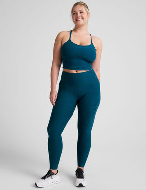 blue high-waisted midi length leggings with side pockets. 