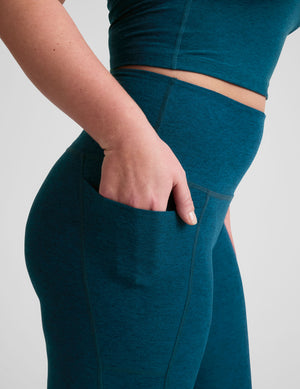 blue high-waisted midi length leggings with side pockets. 