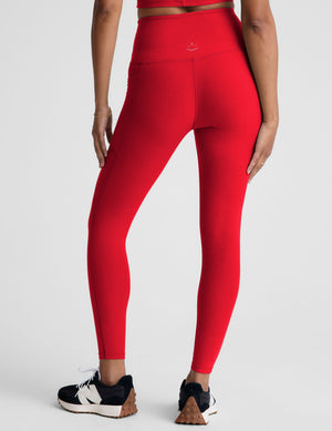 red high-waisted midi leggings with side pockets. 