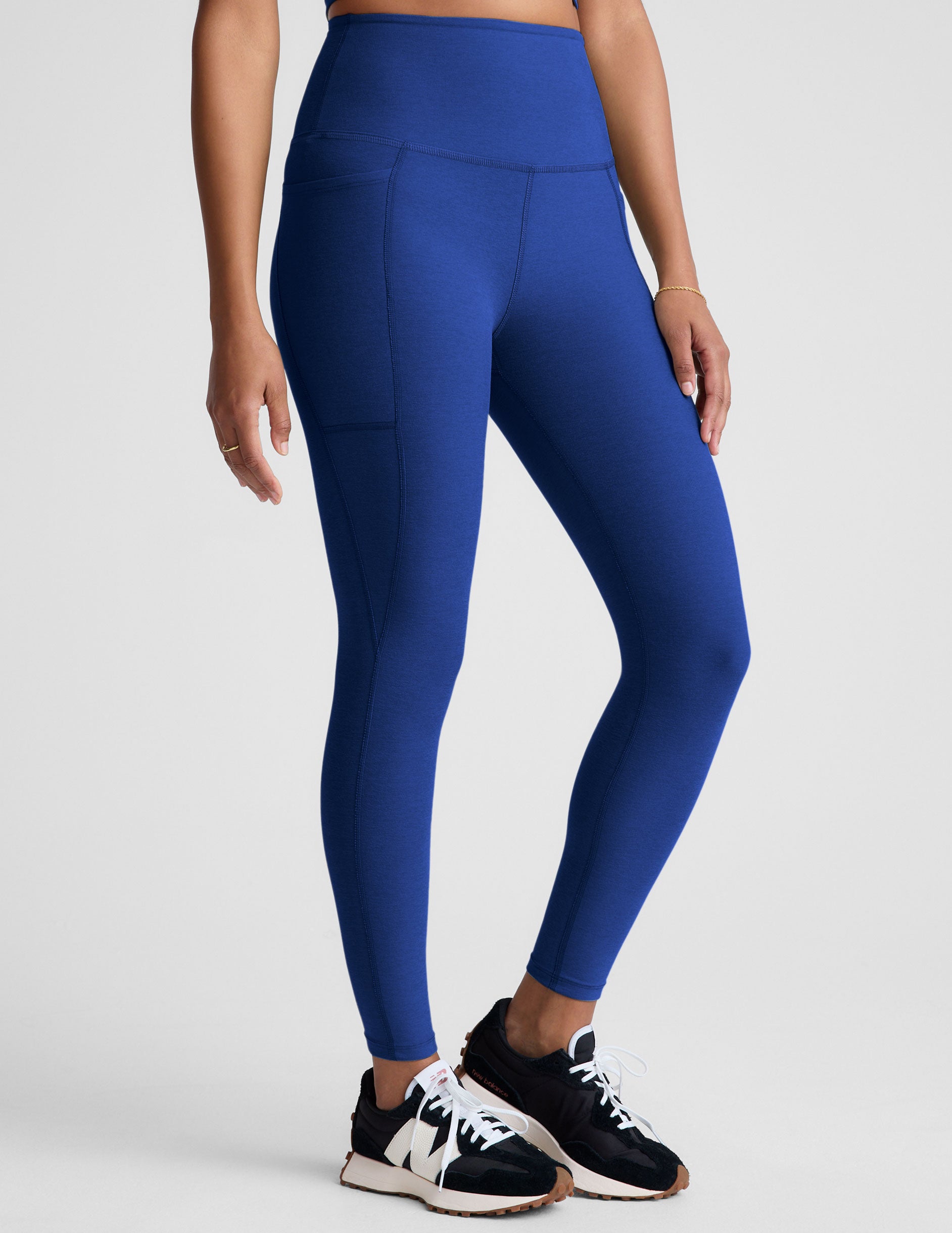 blue high-waisted midi length leggings with side pockets. 