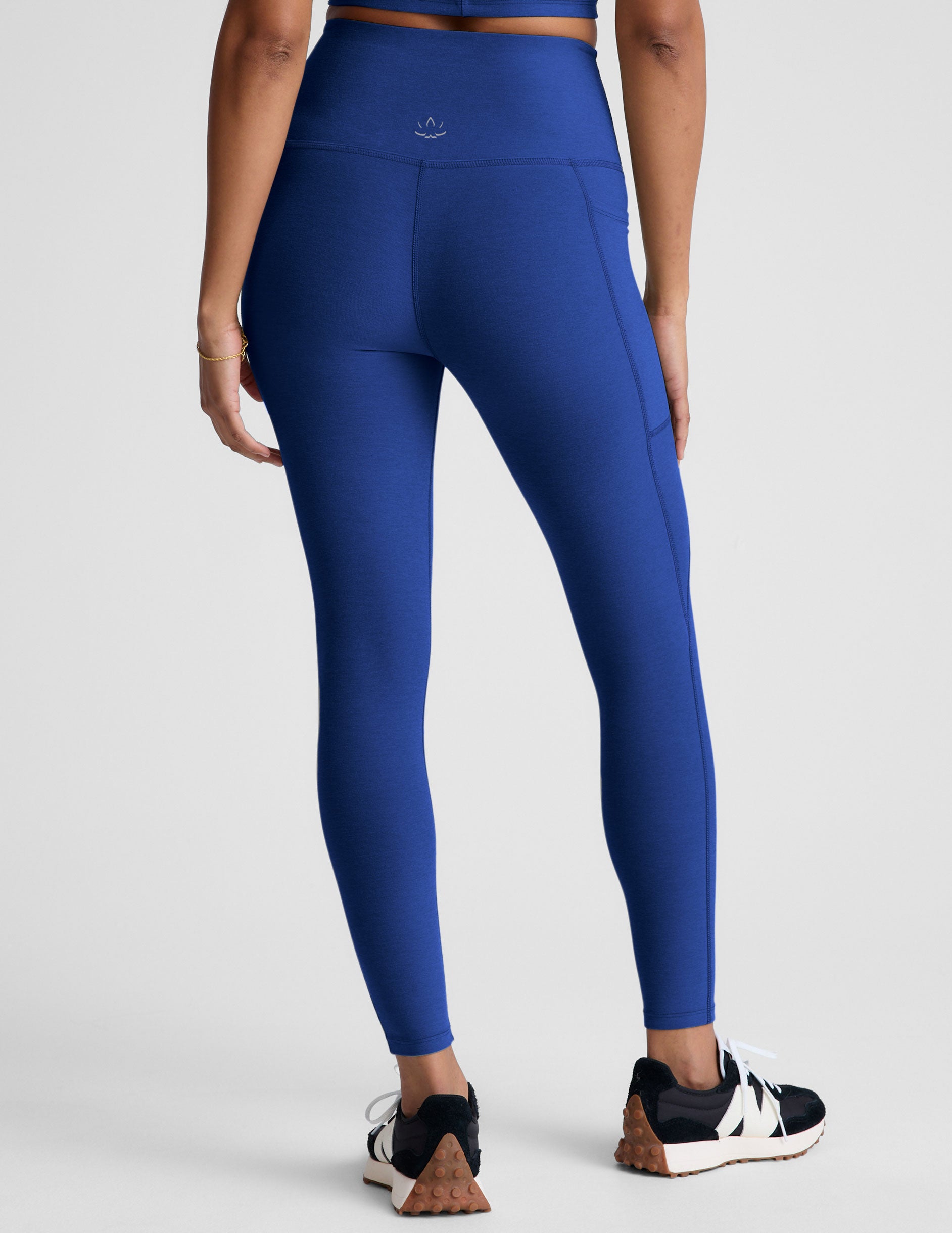 blue high-waisted midi length leggings with side pockets. 