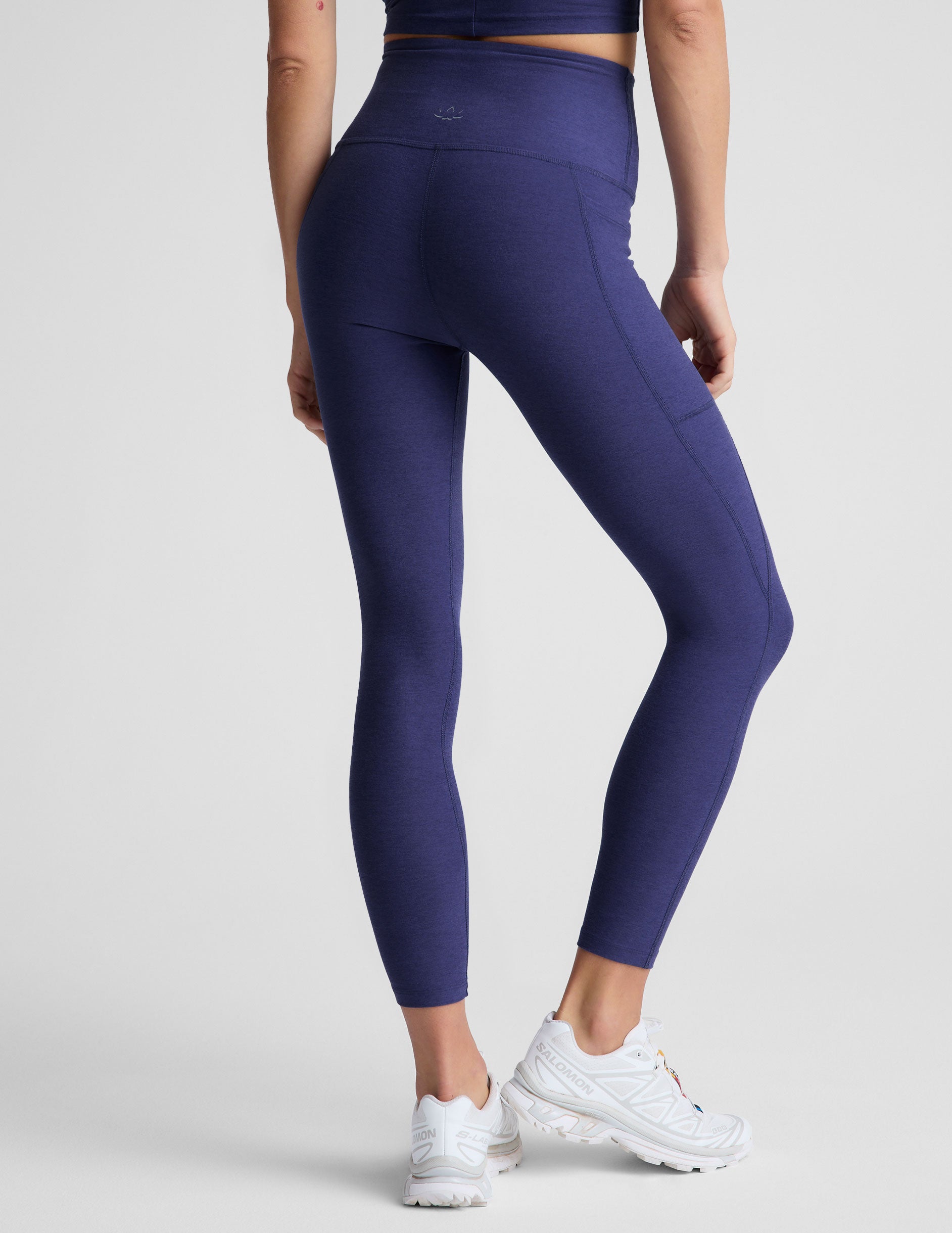 blue midi length high-waisted leggings with side pockets. 