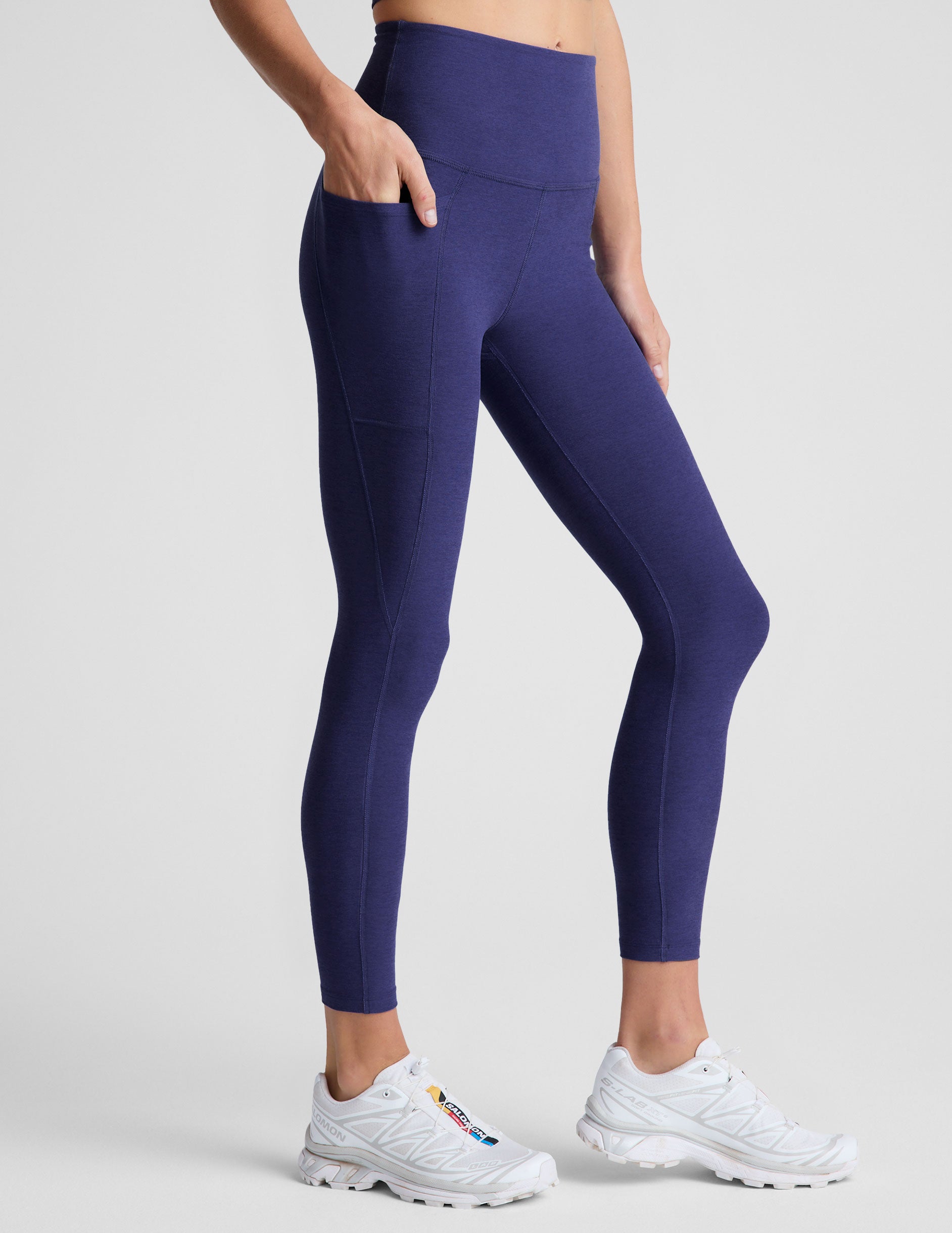 blue midi length high-waisted leggings with side pockets. 