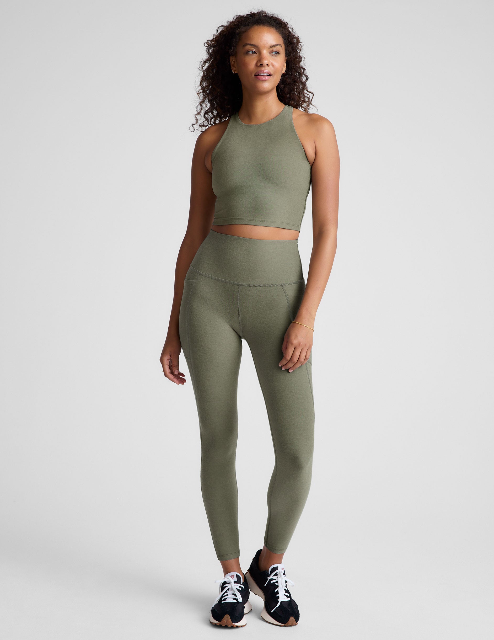 green high-waisted midi length legging with side pockets. 