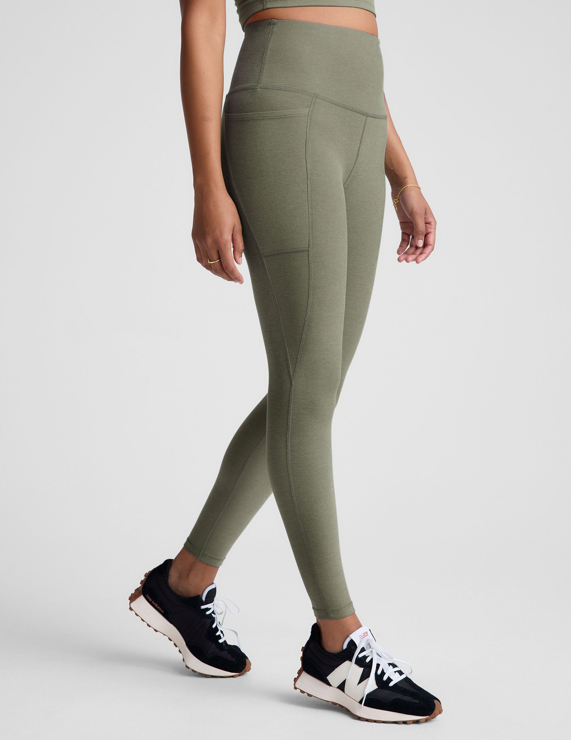 green high-waisted midi length legging with side pockets. 