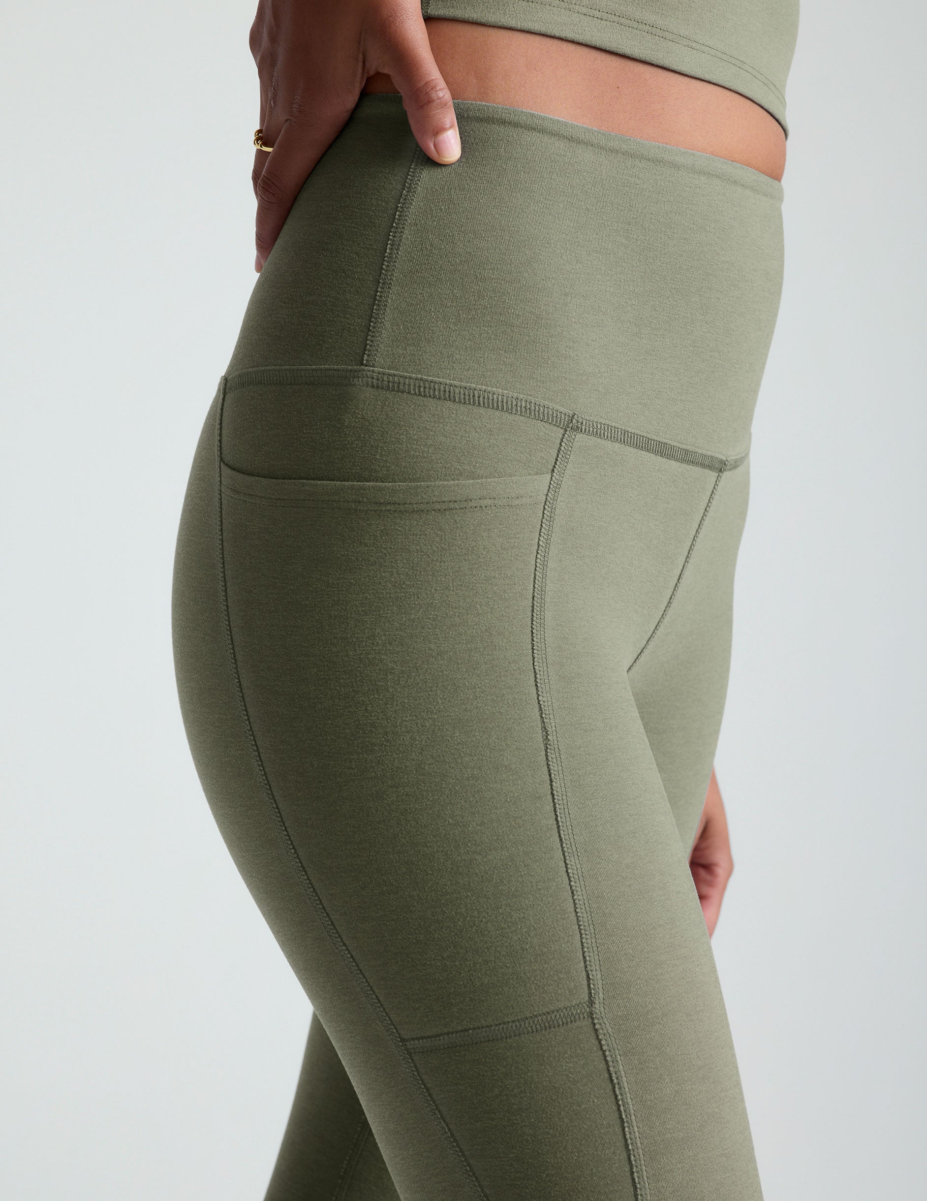 green high-waisted midi length legging with side pockets. 