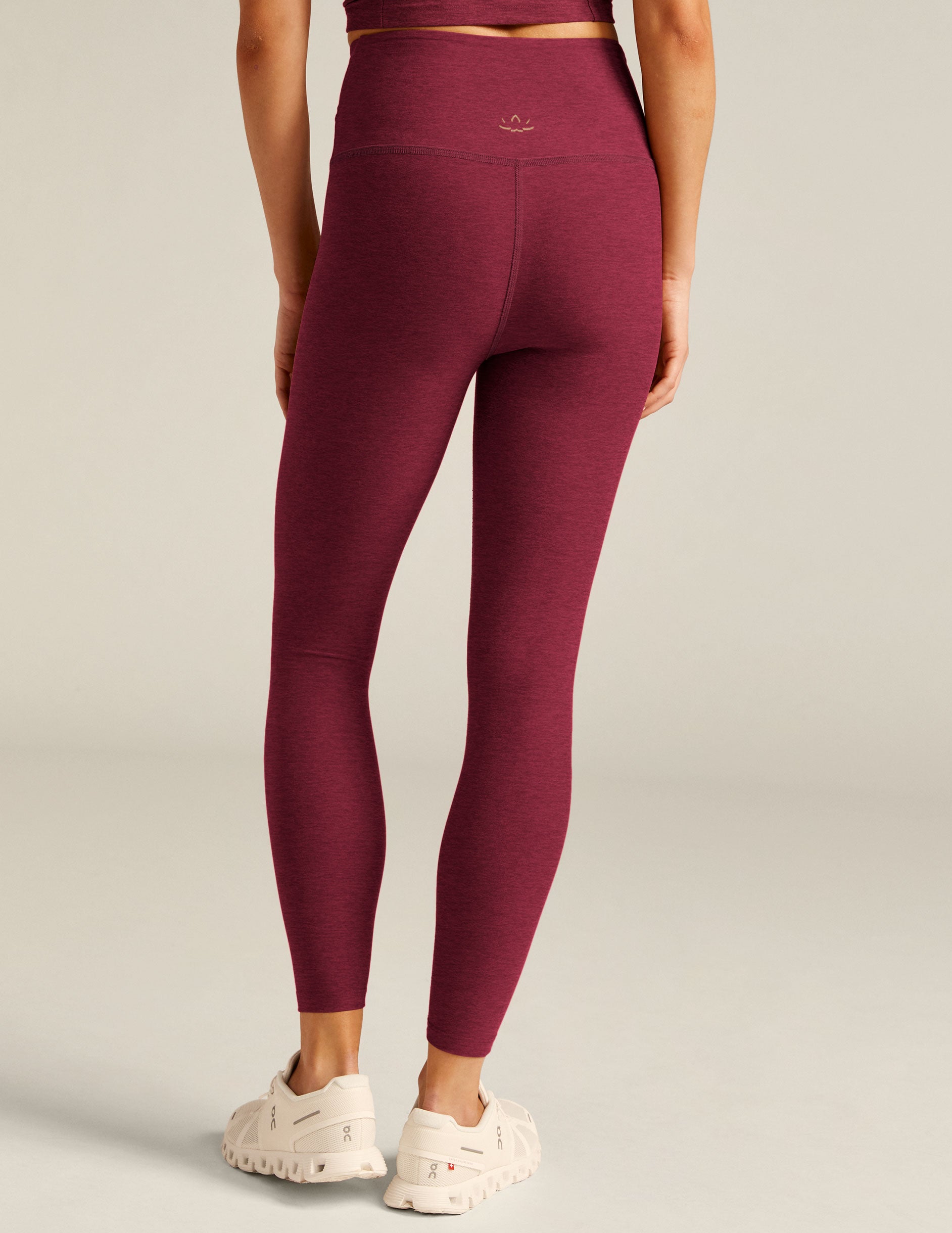 red high-waisted midi leggings with a crossover detail on the front waistband. 