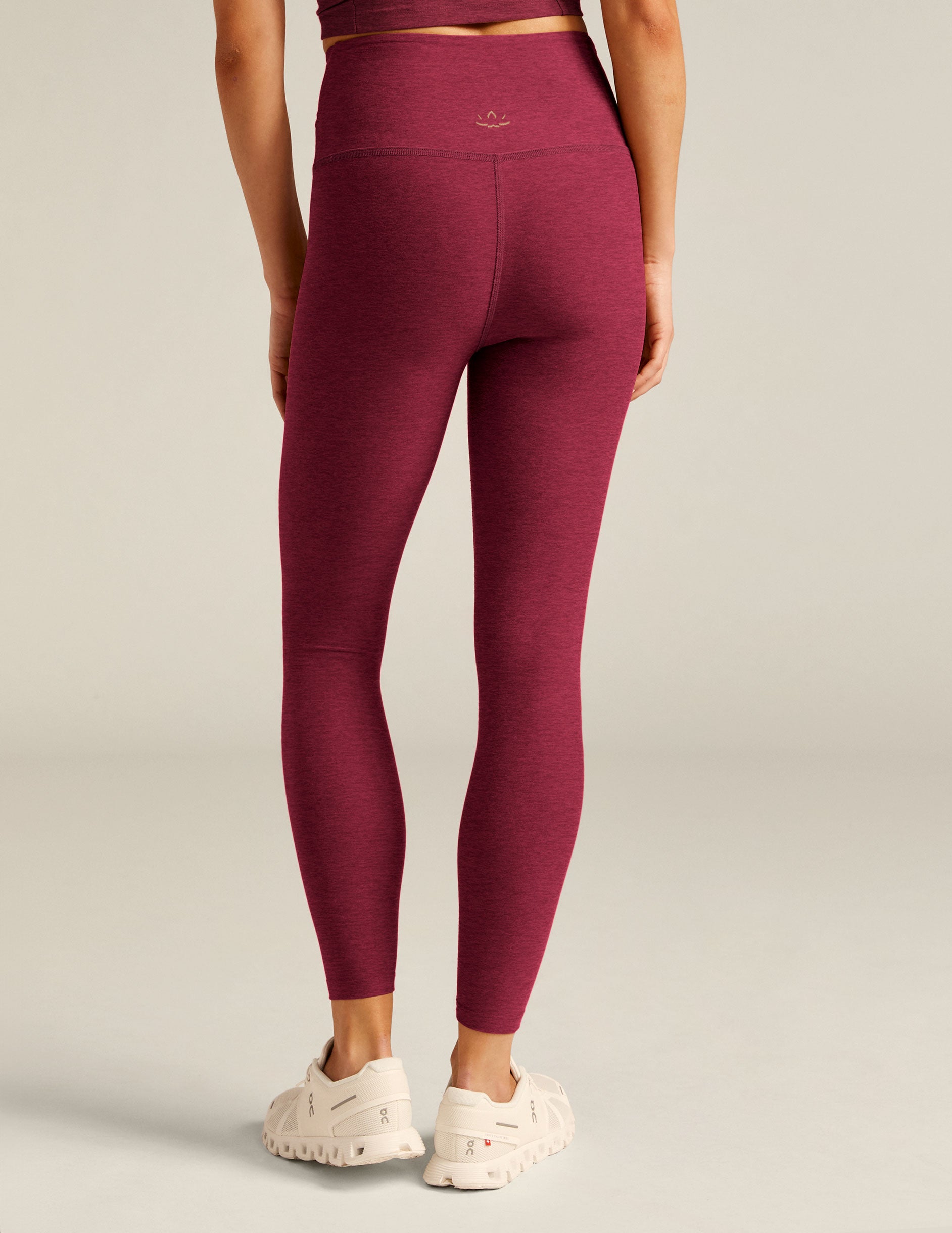 red high-waisted midi leggings with a crossover detail on the front waistband. 