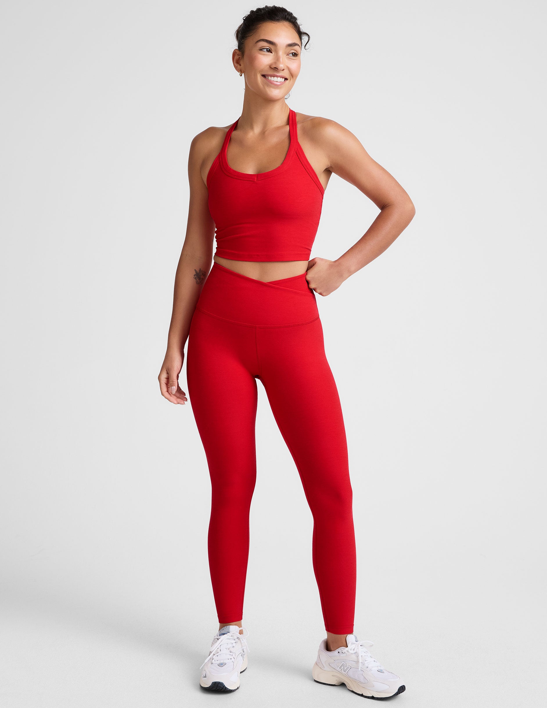 red high-waisted midi legging with criss cross front detail.