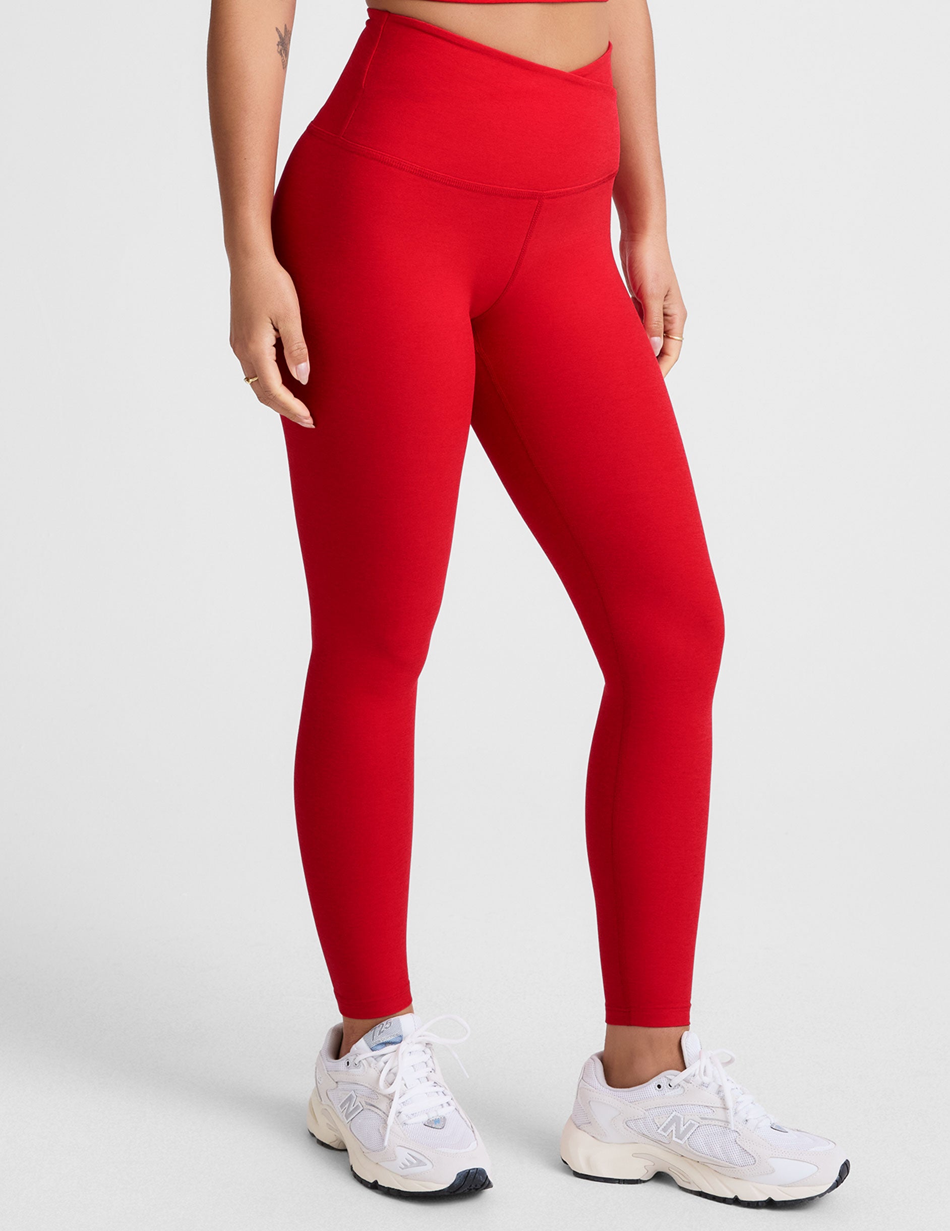 red high-waisted midi legging with criss cross front detail.